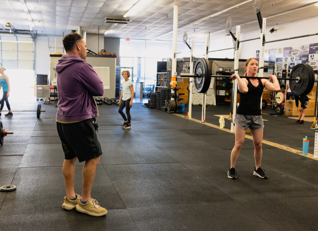Coach working with a member